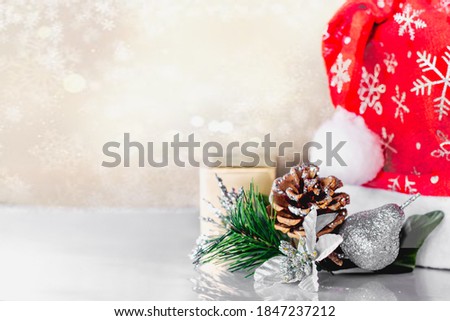 Red Santa Claus hat on red background. Top view. Copy space. Advent time. New year composition. Decoration for winter holidays celebration. Christmas greeting card.