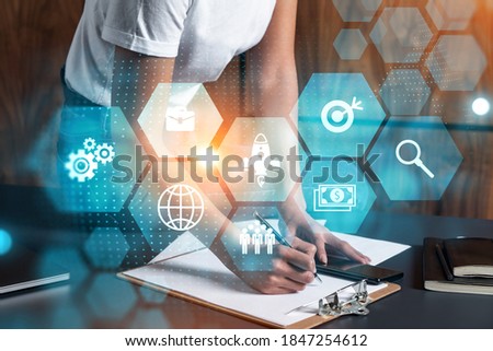 Businesswoman taking notes using smart-phone. Research icons drawings hologram double exposure. Business study concept.