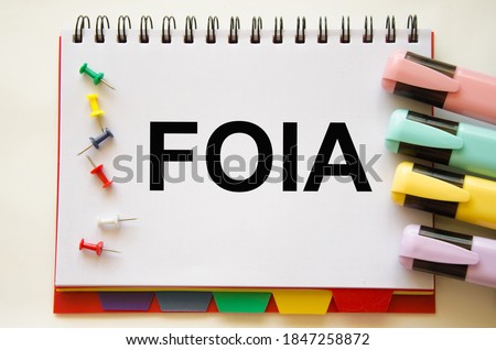  Focused on the business concept. Magnifier glass with the word FOIA Freedom of Information Act on a notepad. Business concept. Search idea. High quality photo