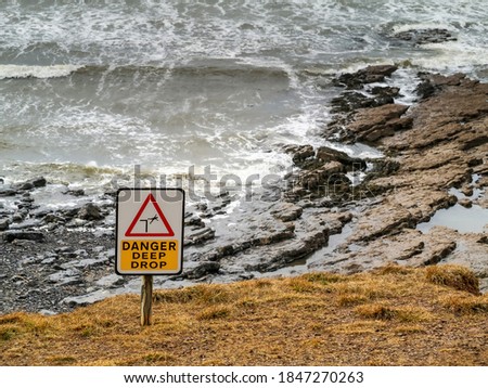 Danger deep drop sign by Atlantic ocean, Rosses point, county Sligo, Ireland.