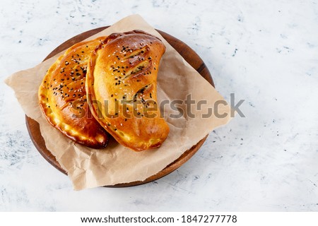 Cornish pasta is a pie with stews, potatoes, cabbage, and spices, including parsley, parsnips and rutabagas.
Cornish pasty is a traditional English dish. Selective focus. Royalty-Free Stock Photo #1847277778