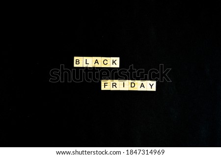 Black Friday written in wooden letters on a black background, sales, holiday sales, top view, flat layout, price reduction
