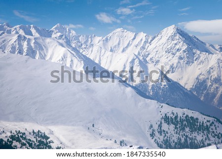 A beautiful view of a big snowy mountain range with a blue sky. Royalty-Free Stock Photo #1847335540