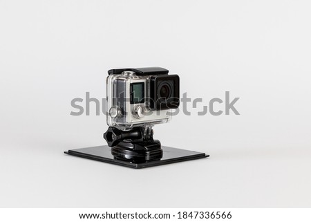 Action camera in waterproof housing and on stand to keep it stationary