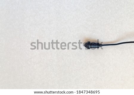 Small size audio microphone isolated on white background. Copy space.
