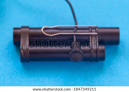 Lavalier microphone with long cable and power module. Close-up