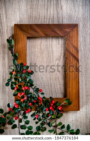 Autumn composition with rustic photo frame decorated with bright ripe Rowen and acorns, top view, copy space