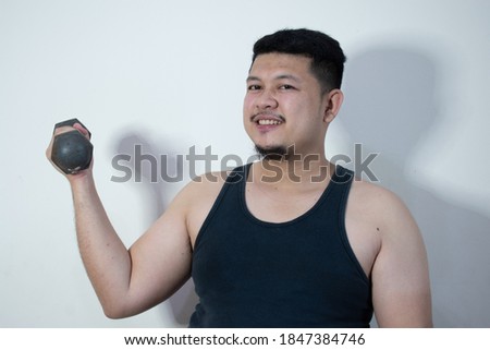 Overweight man doing exercise in white background.