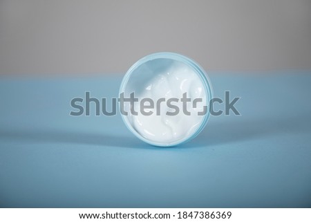face cream on the blue table background