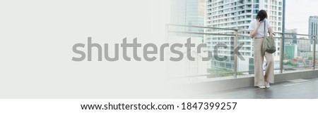 web banner solo asian woman wear protective mask during use phone and relax at rooftop with city background