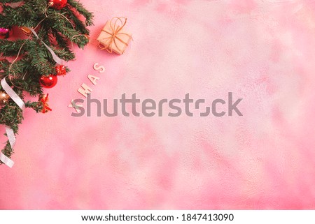 Christmas composition with decorations and gift box with bows on pink pastel background. winter, new year concept. Flat lay, top view, copy space.
