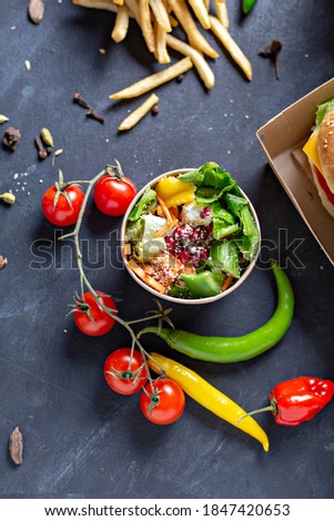 kraft paper food packaging boxes for burgers and  french fries, salad, nagets. on a black background. - image