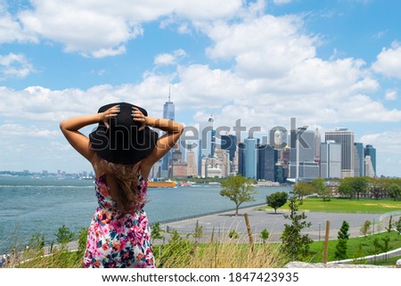 Woman looking at Manhattan's skyline from Governors Island
