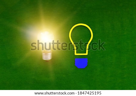 Two light bulbs on a green background. Ideas, creativity. Thinking.