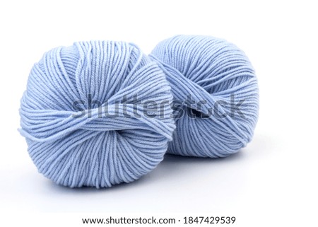 balls of light blue and dark blue woolen thread on  white  background. natural wool. knitting. background