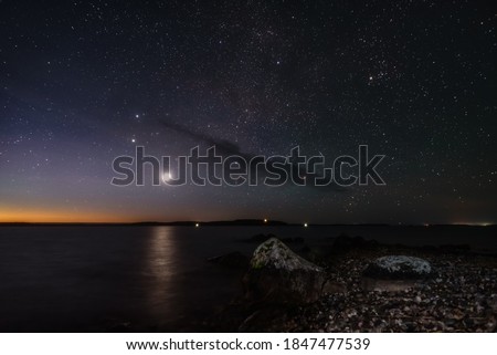 Bright light of Venus in the night sky over Lake Onega. Russia, Republic of Karelia