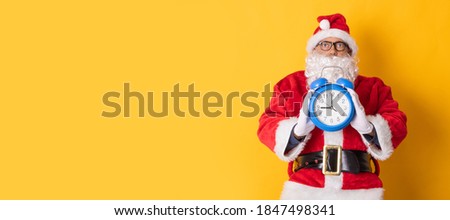 santa claus isolated on background with clock or alarm clock