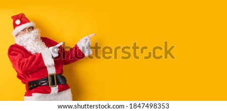 santa claus isolated on background pointing for ad or text