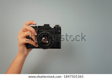 photo camera in one hand of a girl Royalty-Free Stock Photo #1847501365