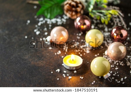 Christmas composition. Christmas glossy ball and a candle.