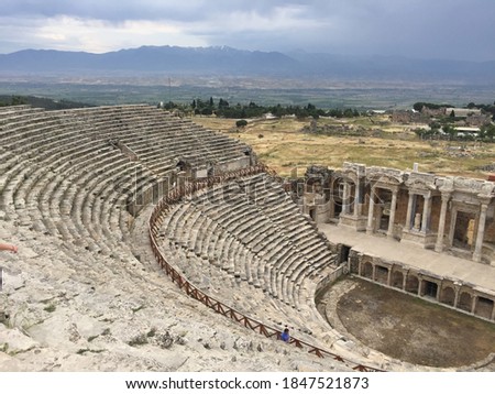 Amphitheater in ancient city of Hierapolis. Dramatic sunset sky. Unesco Cultural Heritage Monument. Pamukkale, Turkey