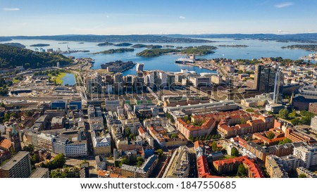 Oslo, Norway. Beautiful panoramic aerial view photo from flying drone for Oslo city center. Against the background of the sea, mountains and blue sky on a sunny summer day. (Series) Royalty-Free Stock Photo #1847550685
