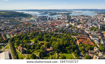 Oslo, Norway. Beautiful panoramic aerial view photo from flying drone for Oslo city center. Against the background of the sea, mountains and blue sky on a sunny summer day. (Series)