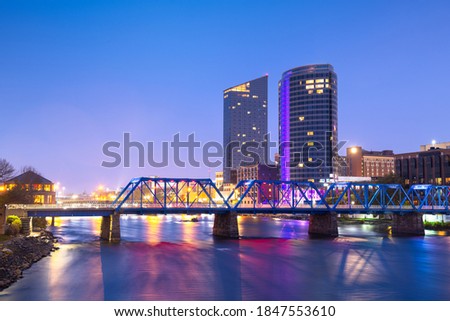 Grand Rapids, Michigan, USA downtown skyline on the Grand River at dusk. Royalty-Free Stock Photo #1847553610