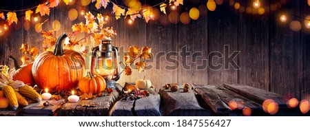 Thanksgiving - Old Table With Pumpkins And Corns With Bokeh Lights In Dark Background