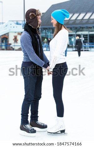 Beautiful, attractive couple on the ice rink