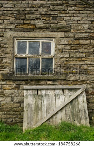 The old wooden gate leaning against the 1700's farmhouse.