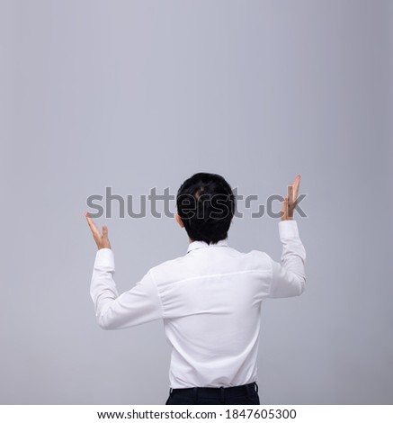 Office Man white shirt turn back rear view and express feeling through his head and hands with Big Empty copy space on Gray background isolated