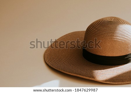 Wide brim straw hat on beige