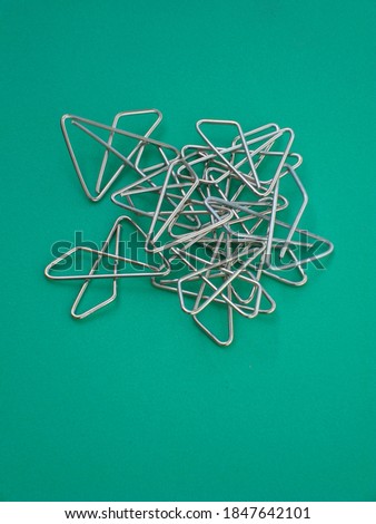 Metal clips on green surface