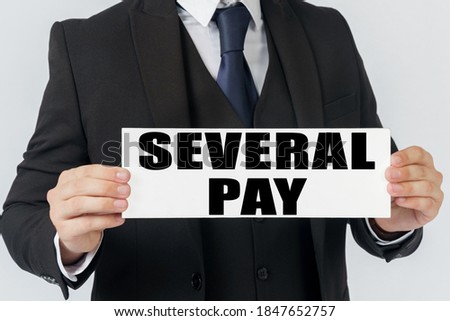 Business and finance concept. A businessman holds a sign in his hands which says SEVERAL PAY