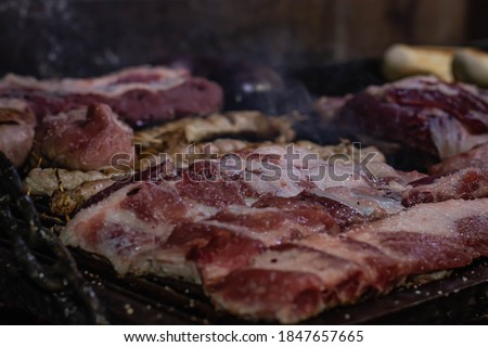 typical and traditional Argentine barbecue beef pork chinchulin
  beef intestine black pudding chorizo rib on charcoal grill córdoba argentina