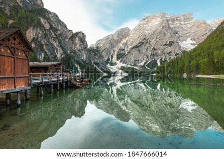 panoramic view of Mount Seekofel and boatshouse mirroring in the clear calm water of iconic mountain lake Pragser Wildsee (Lago di Braies) in Dolomites, Unesco World Heritage, South Tyrol, Italy Royalty-Free Stock Photo #1847666014