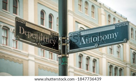 Street Sign the Direction Way to Autonomy versus Dependency Royalty-Free Stock Photo #1847736439