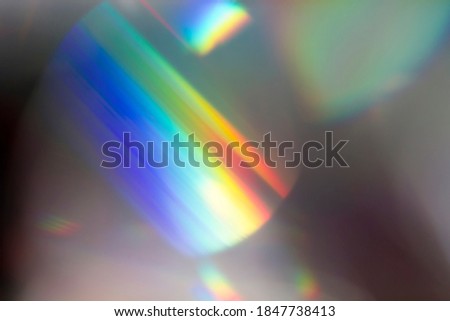 Colourful lens flare and haze on black background.
