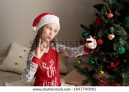 A girl in a new year's costume takes pictures of herself on the phone