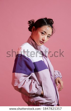 Young Asian woman with glitter make-up wearing sporty fashion Royalty-Free Stock Photo #1847821357