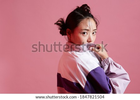 Young Asian woman with glitter make-up wearing sporty fashion