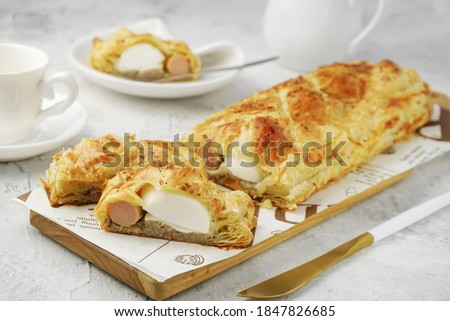 A picture of food photography that focus on slice of Picnic Roll Pastry as snack  for a tea companion in white background