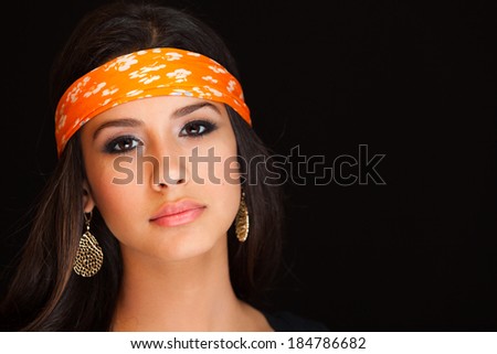 Beautiful young woman on a black background.