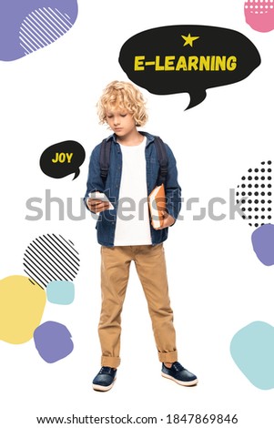 blonde schoolboy holding book and using smartphone near speech bubbles with joy and e-learning words on white