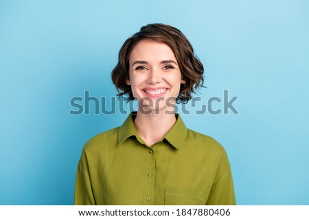 Photo portrait of funny positive optimistic girl with short haircut and wavy hair smiling laughing isolated on blue color background