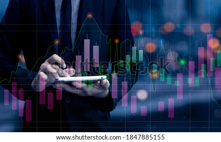 Double exposure of financial graph. Stock market chart. Businessman hand using tablet and stock market or forex graph, Forex investment business internet technology concept, Blurred background.