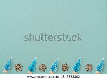 Top view of Christmas holiday pattern decoration ornament composition with Christmas tree objects flat lay with copy space isolated on green background.