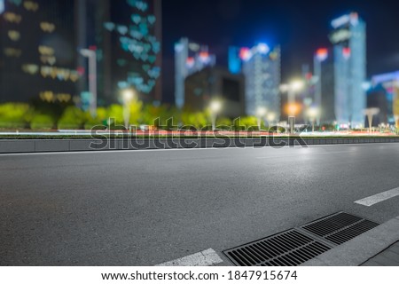 urban traffic road with cityscape in background at night