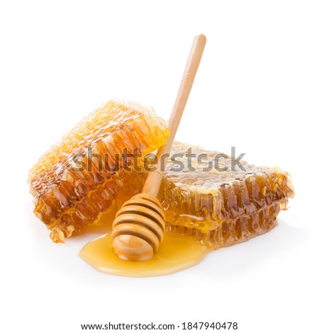 Honeycomb with honey spoon isolated on white background 